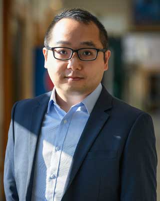 chest-up portrait of Ka Ho Leung in a blue suit jacket and open-collared light blue shirt