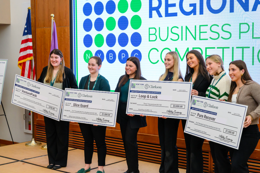 Students holding checks for cash they have won