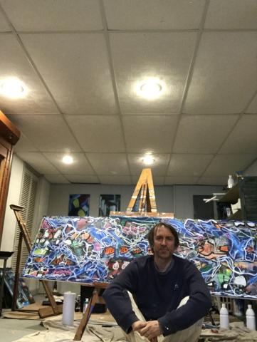 Jason Schmitt in front of his artwork