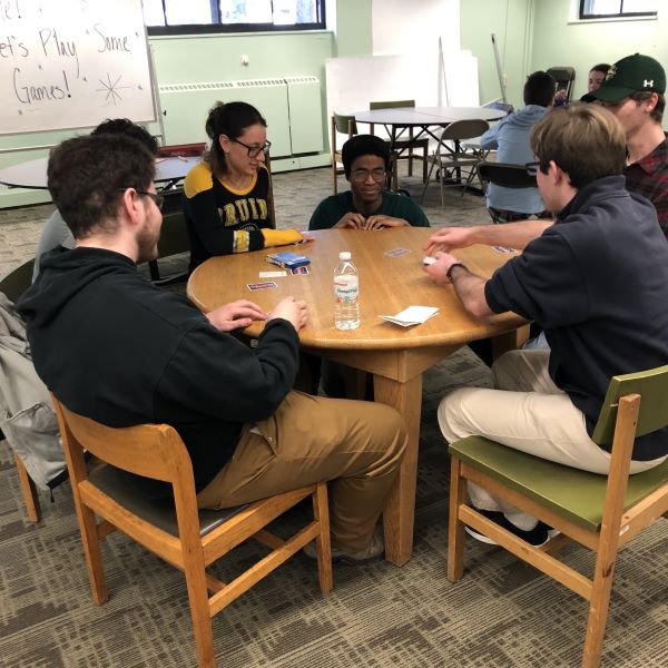 A photo of the golden gamers learning living community playing board games.