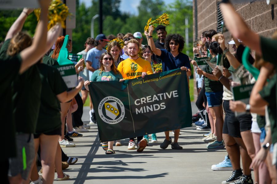 A photo of the fall 2024 creative minds living learning community holding a banner