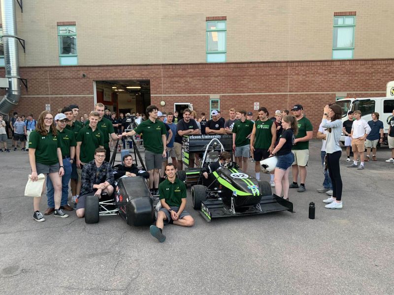 A photo of the formula sae electric team standing around their car