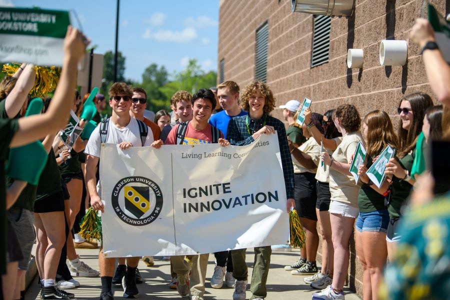 A photo of the Fall 2024 Ignite innovation living learning community holding a banner