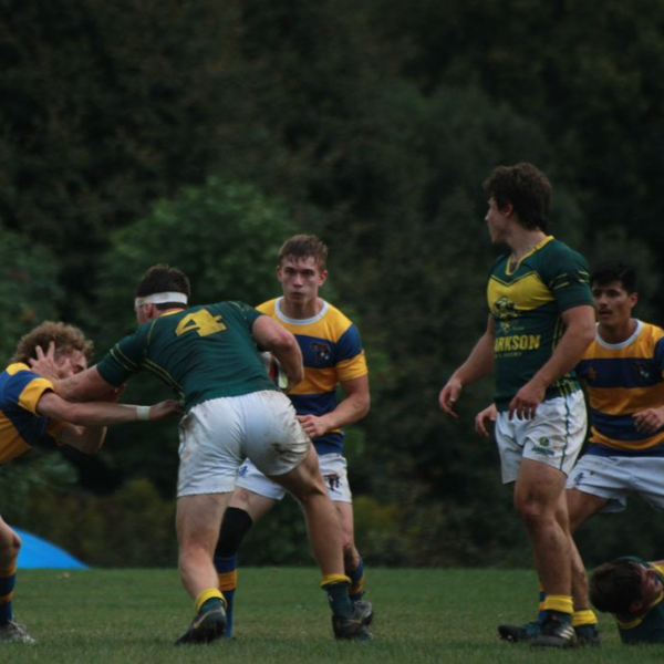 A photo of students on the men's rugby team during a game