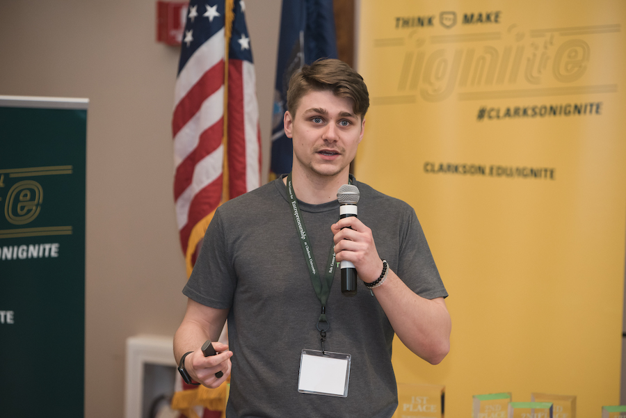 Young man speaks into a handheld microphone 