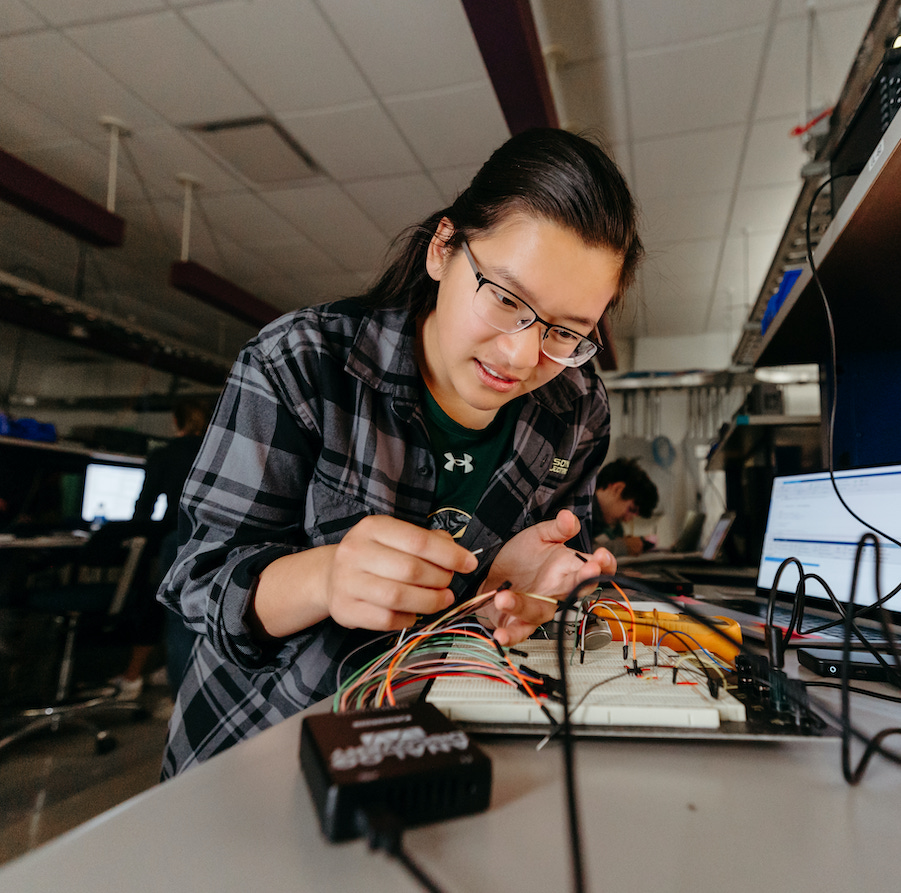 Female student at Clarkson University at a computer station.
