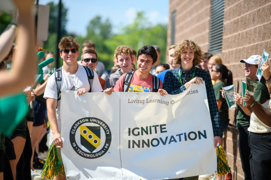 Students hold Ignite Innovation banner after winning scholarships