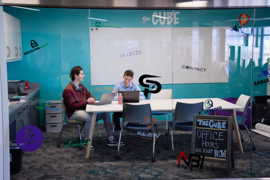 2 students sitting in "The Cube" room